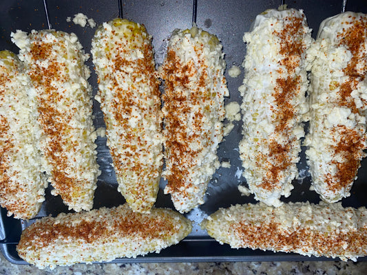 ELOTES (CORN TOPPED WITH COTIJA CHEESE AND TAJIN)